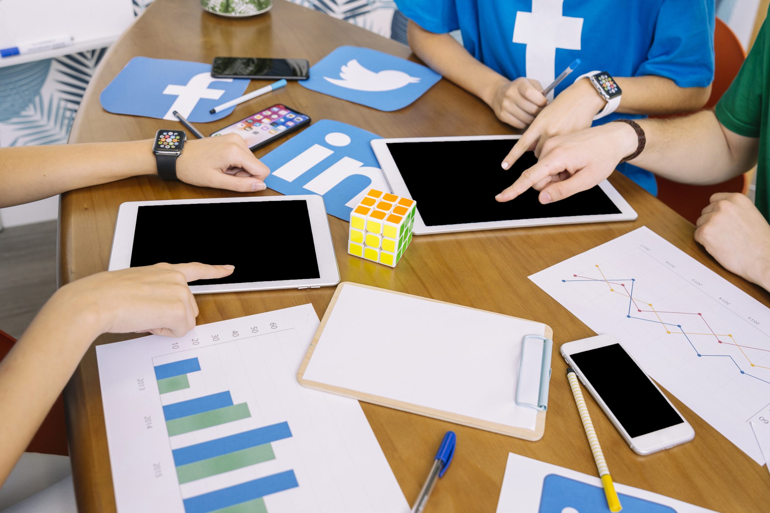 social media team using digital tablet with social media icons desk scaled 1